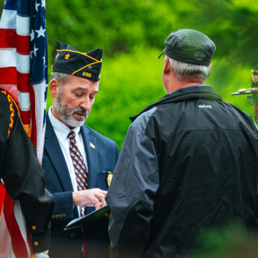 soldiers in uniforms standing with flag by chris f on pexels (cropped)